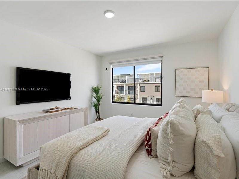 14608 Southwest 261st Terrace Homestead, FL 33032 - Photo 10 of 26 a bedroom with a bed and a flat screen tv