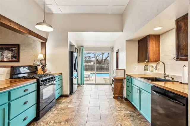 a large kitchen with stainless steel appliances granite countertop a stove and a sink