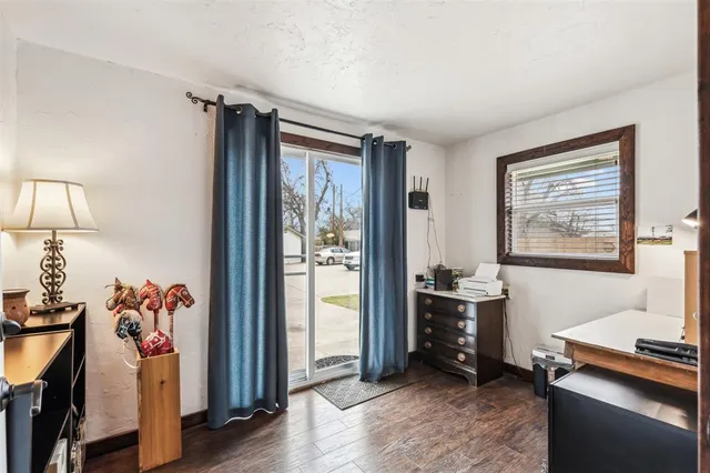 a view of a workspace with furniture and a window