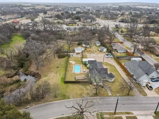 an aerial view of residential houses with outdoor space