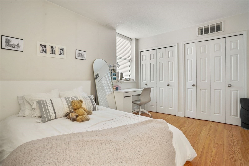 841 Parker Street, Unit 101 Boston, MA 02120 - Photo 11 of 19 a bedroom with a bed and a window