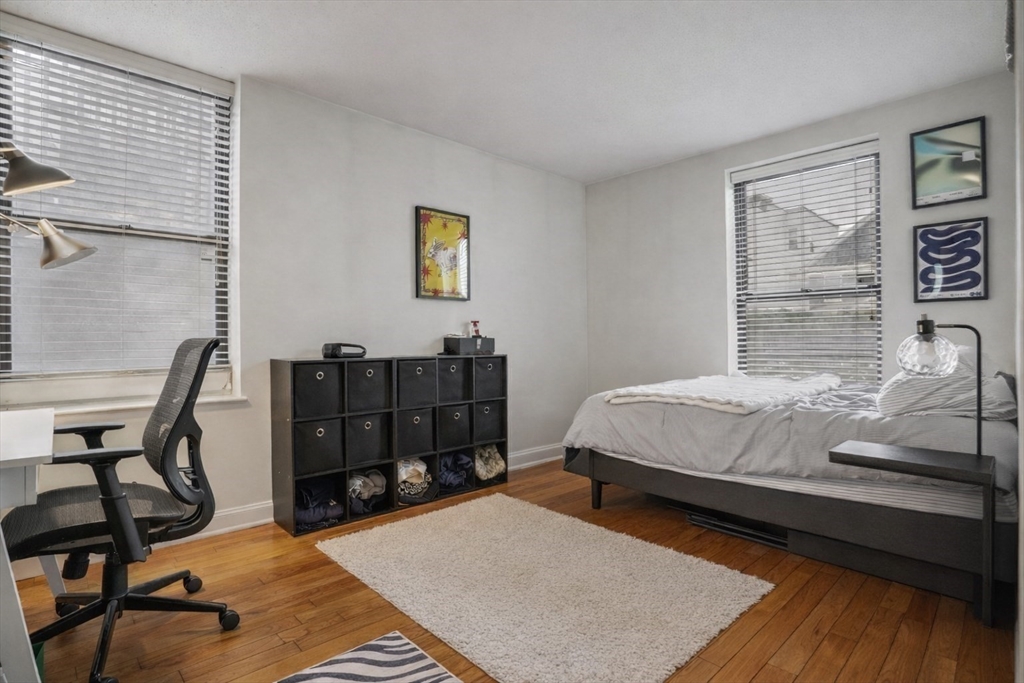 841 Parker Street, Unit 101 Boston, MA 02120 - Photo 12 of 19 a bed sitting in a bedroom next to a window