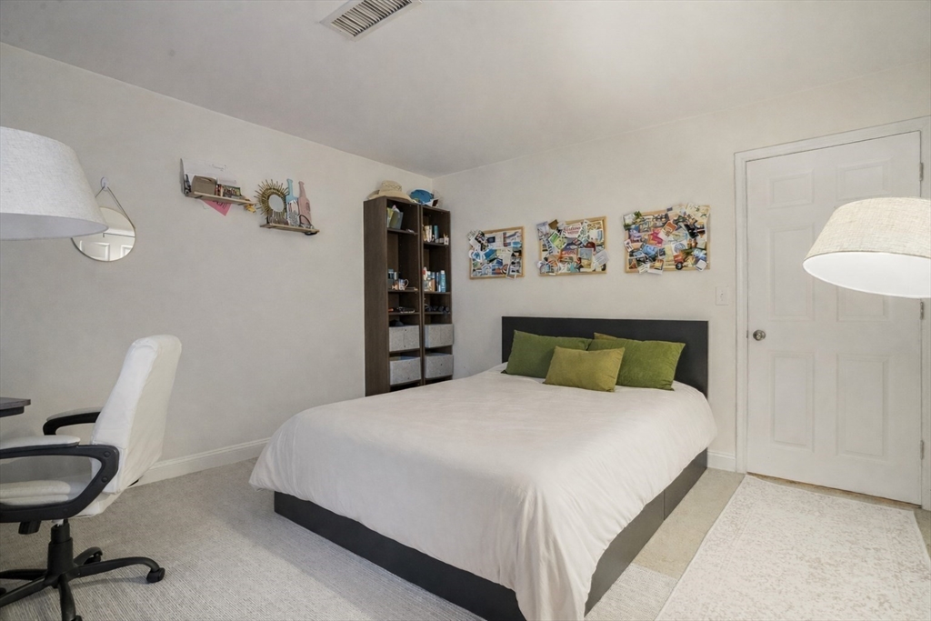 841 Parker Street, Unit 101 Boston, MA 02120 - Photo 13 of 19 a bedroom with a bed and a table in it