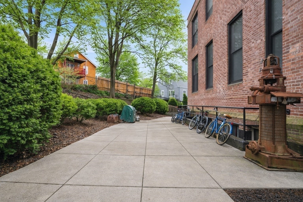841 Parker Street, Unit 101 Boston, MA 02120 - Photo 16 of 19 a pathway of a house with a yard