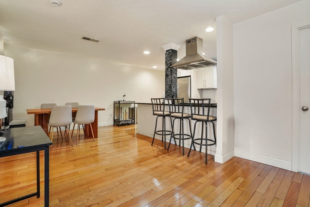 841 Parker Street, Unit 101 Boston, MA 02120 - Photo 2 of 19 a room with lots of chairs and wooden floor