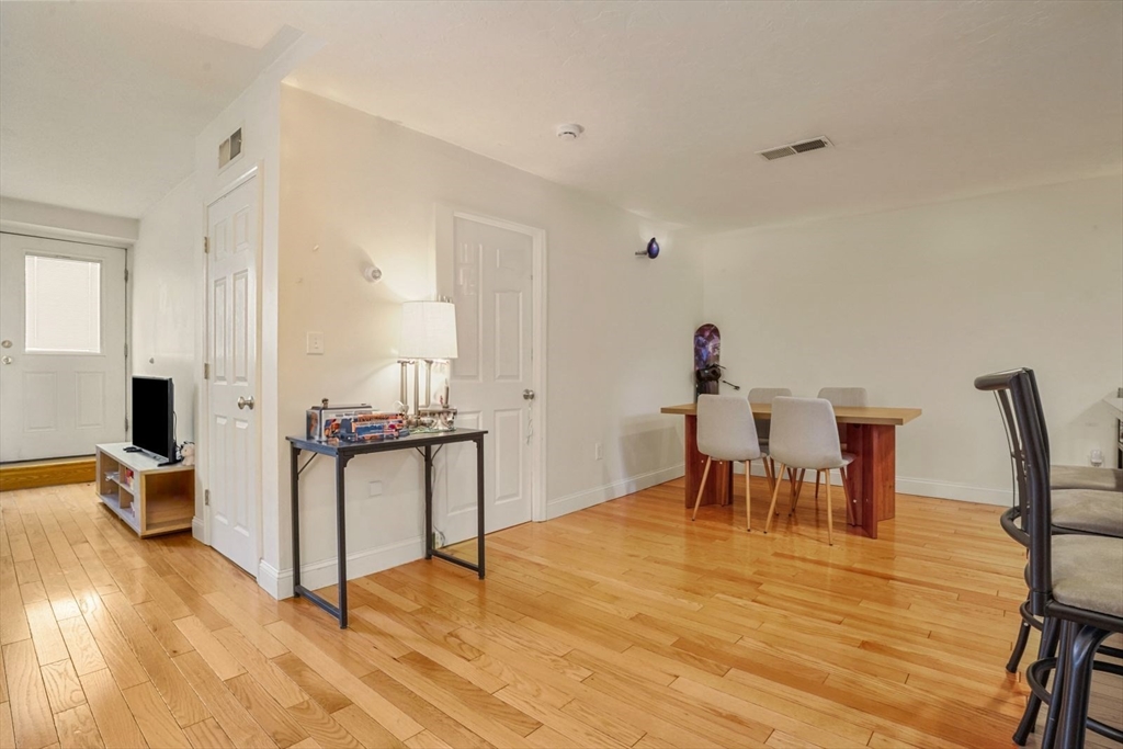 841 Parker Street, Unit 101 Boston, MA 02120 - Photo 3 of 19 a dining room with furniture and wooden floor