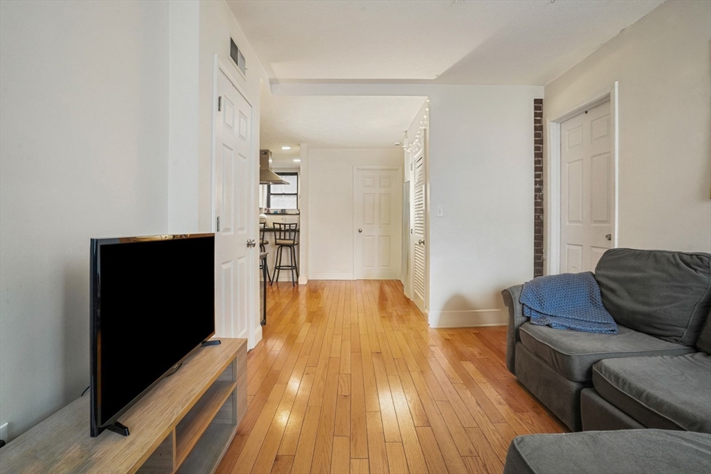 841 Parker Street, Unit 101 Boston, MA 02120 - Photo 8 of 19 a living room with furniture and a flat screen tv