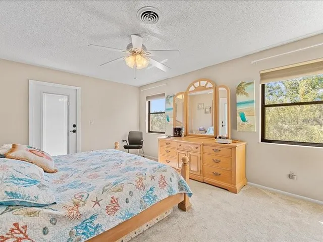 a bedroom with a large bed and a large window