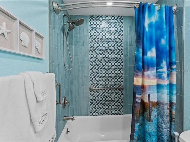 a bathroom with a shower and a sink