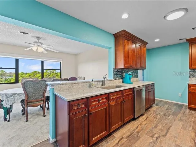 a kitchen with a sink cabinets and wooden floor