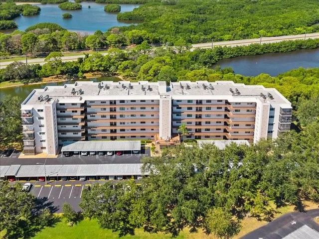 an aerial view of a building with outdoor space and lake view