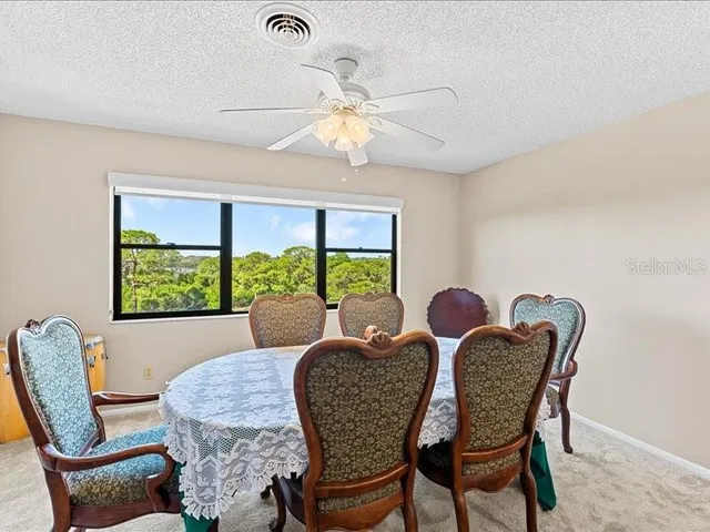 a dining room with furniture a chandelier and a rug