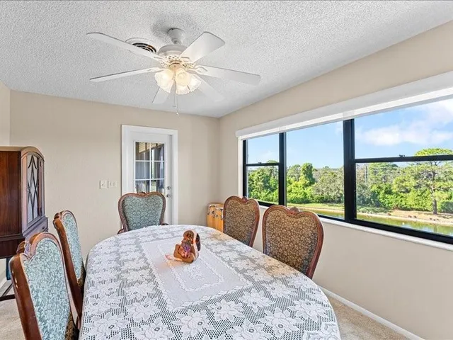 a view of a dining room with furniture window and outside view