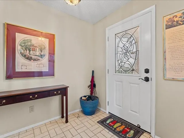 a room with painting on the wall and a window