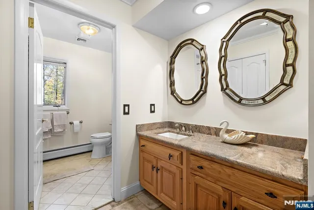 a bathroom with a granite countertop double vanity sink and a mirror