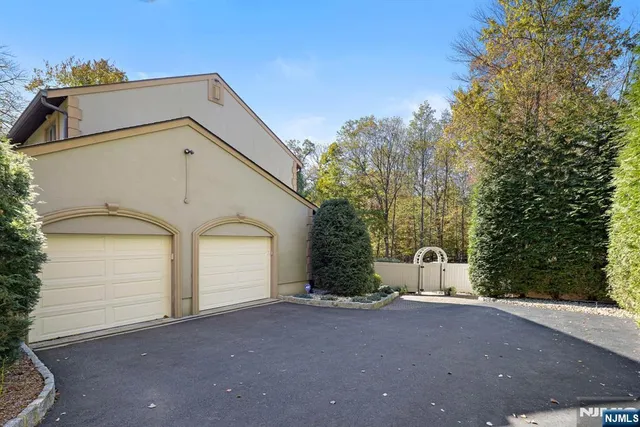 a view of a house with a yard and garage