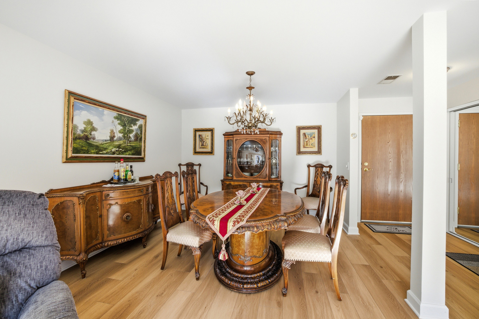 815 Leicester Road, Unit 109 Elk Grove Village, IL 60007 - Photo 11 of 31 a living room with furniture a dining table and a chandelier