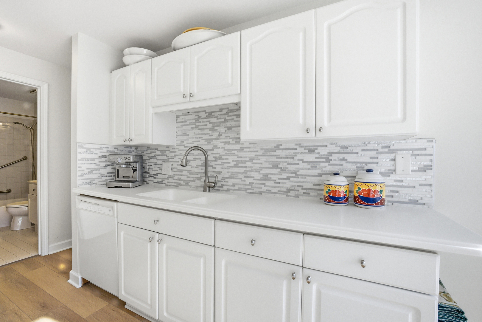 815 Leicester Road, Unit 109 Elk Grove Village, IL 60007 - Photo 3 of 31 a kitchen with stainless steel appliances white cabinets and a sink