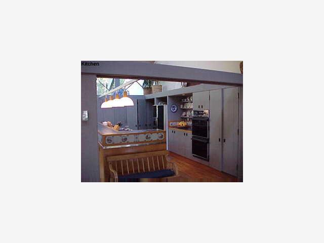 1457 Riata Road Pebble Beach, CA 93953 - Photo 5 of 8 a kitchen with stainless steel appliances kitchen island granite countertop a refrigerator and a sink