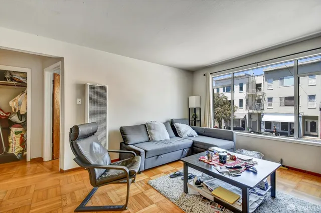 a living room with furniture and a floor to ceiling window