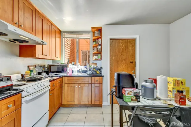 a kitchen with a sink stove and cabinets