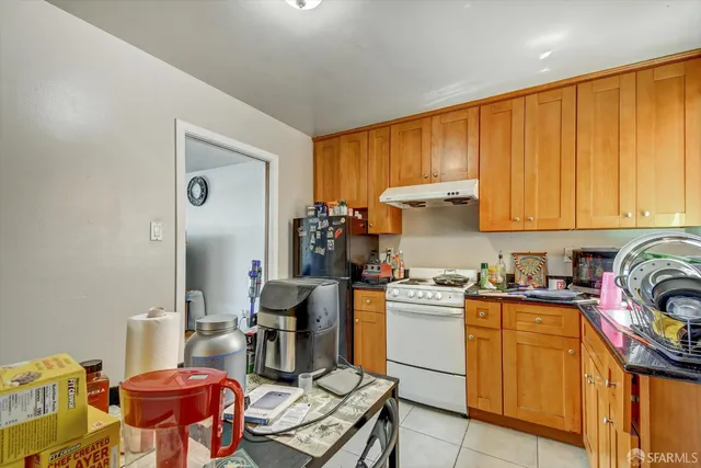 a kitchen with a stove top oven a sink and cabinets