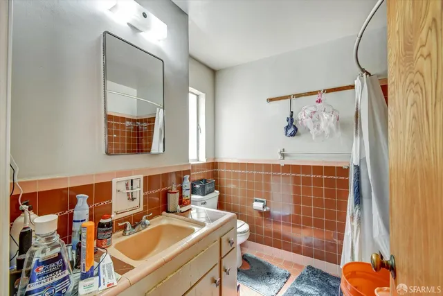 a bathroom with a sink mirror and shower