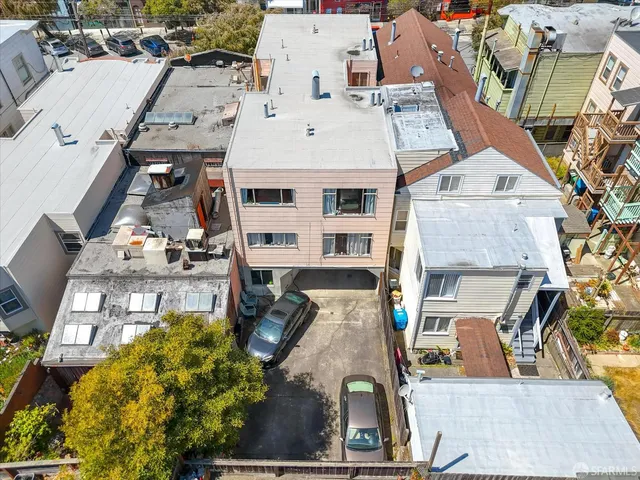 an aerial view of residential houses with outdoor space