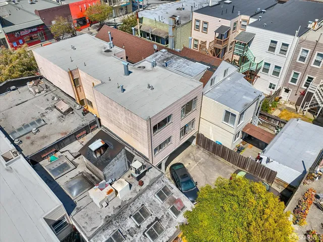 an aerial view of a house with a yard