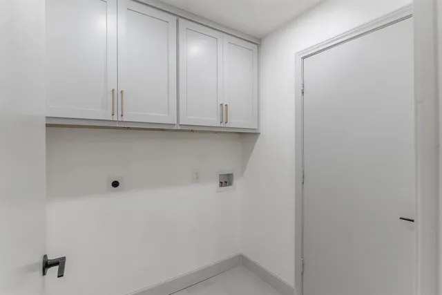 a view of empty room with a fireplace and fan