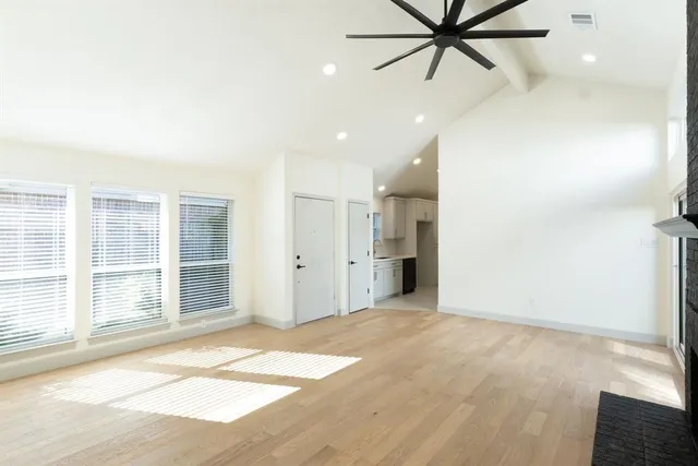 an empty room with closet and windows