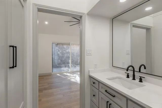 a bathroom with a sink toilet a mirror and shower