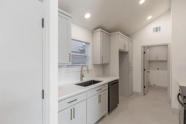 a kitchen with stainless steel appliances a stove microwave and refrigerator