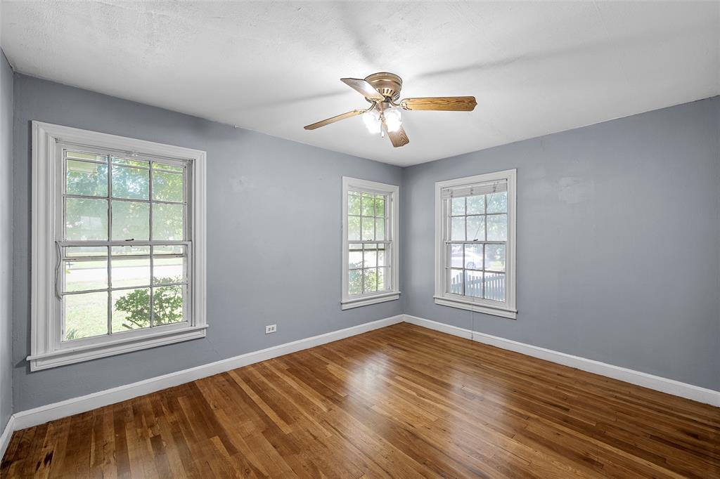 3225 Windsor Avenue Waco, TX 76708 - Photo 12 of 25 Hardwood flooring complemented by light gray walls and white trim