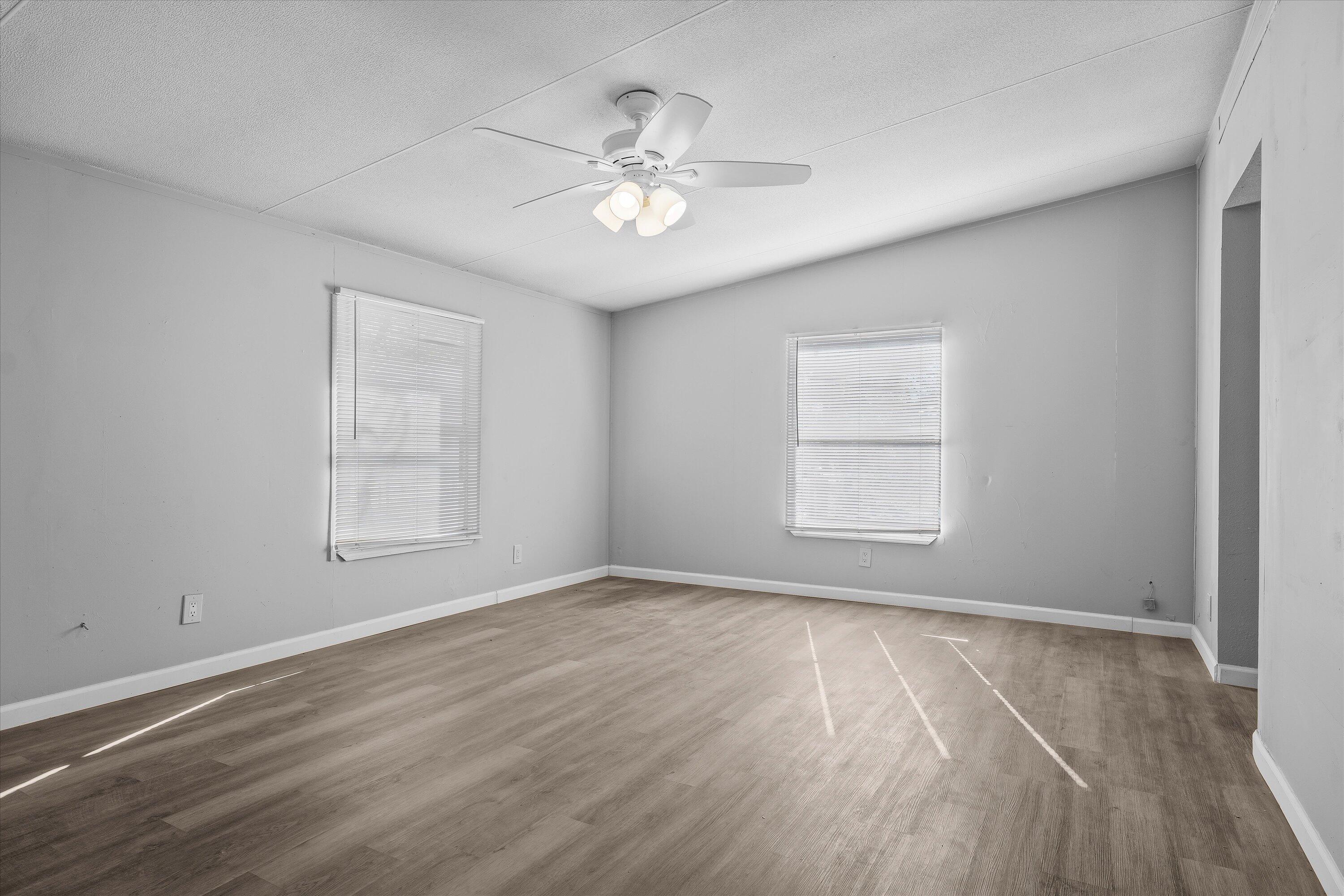 9909 North Chester Avenue Lubbock, TX 79415 - Photo 14 of 24 wooden floor in an empty room with a window