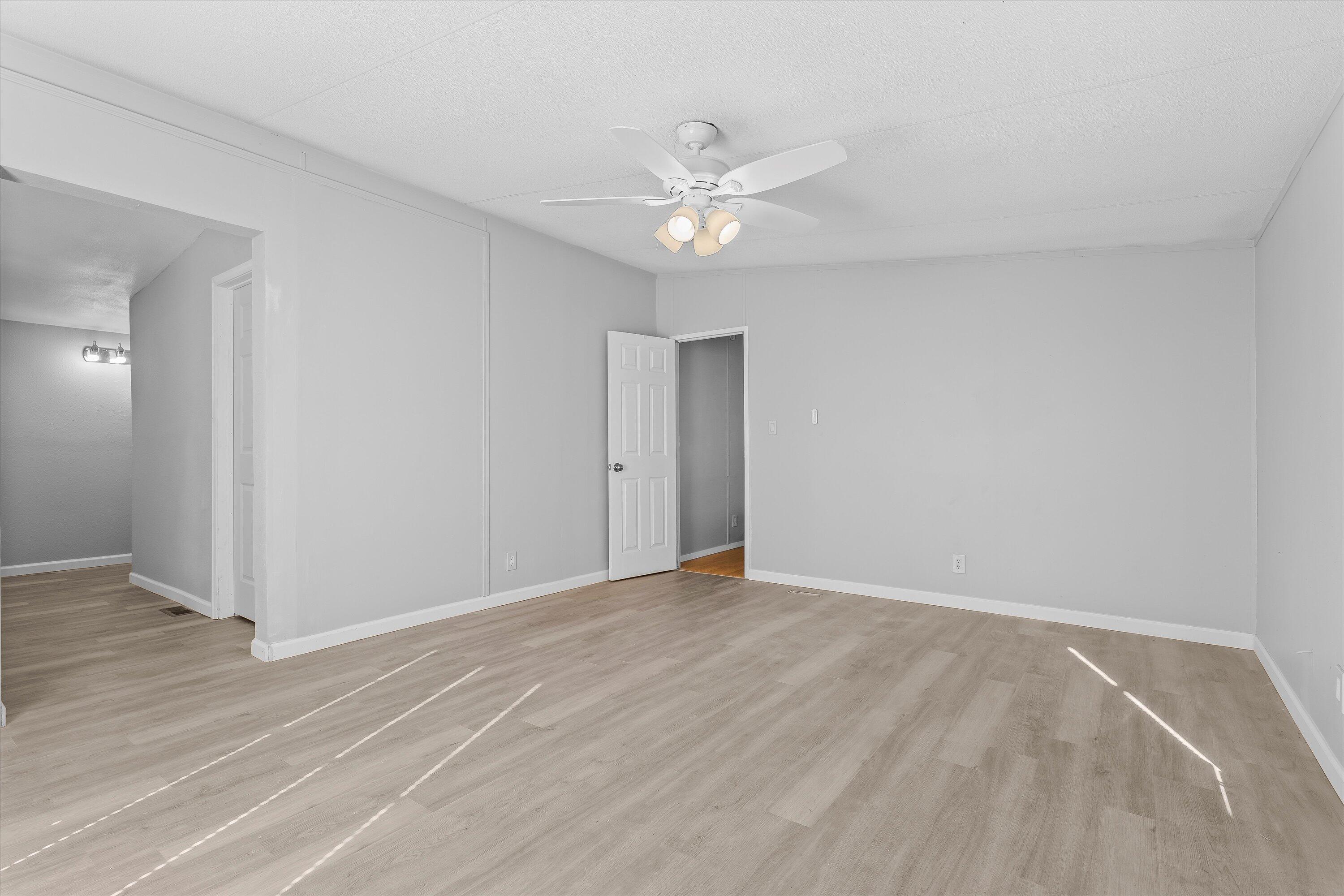 9909 North Chester Avenue Lubbock, TX 79415 - Photo 15 of 24 a view of an empty room with wooden floor