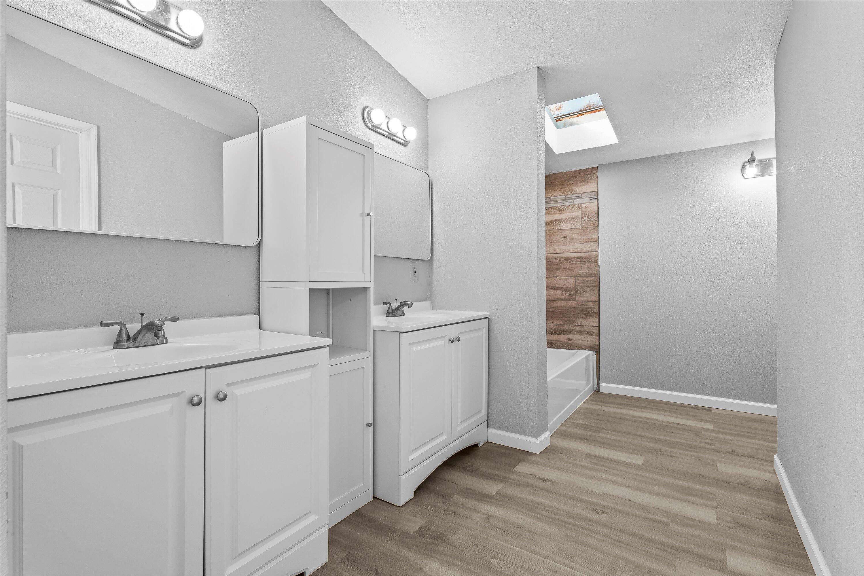 9909 North Chester Avenue Lubbock, TX 79415 - Photo 16 of 24 a room with a sink cabinets and wooden floor