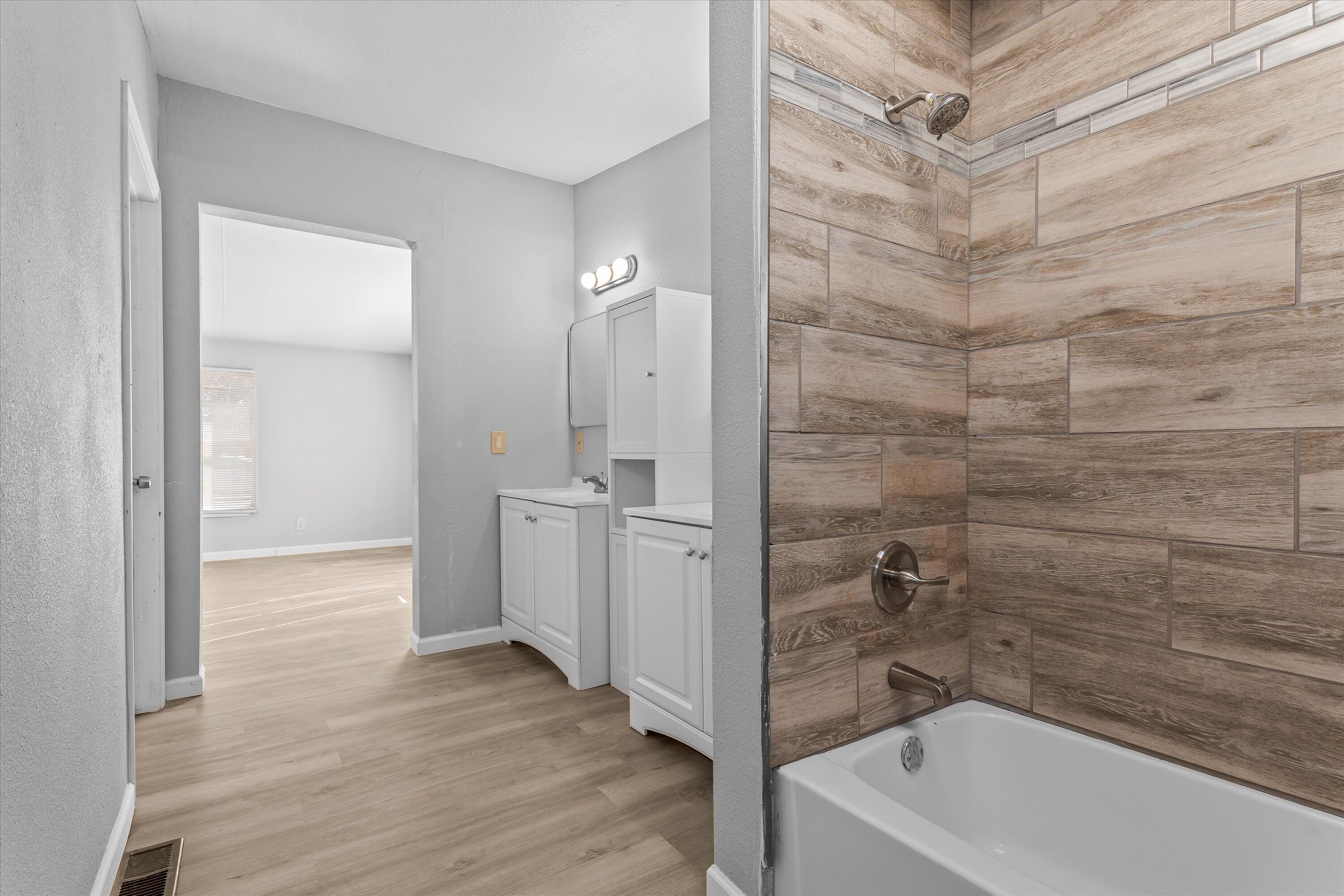 9909 North Chester Avenue Lubbock, TX 79415 - Photo 18 of 24 a bathroom with a bathtub and shower