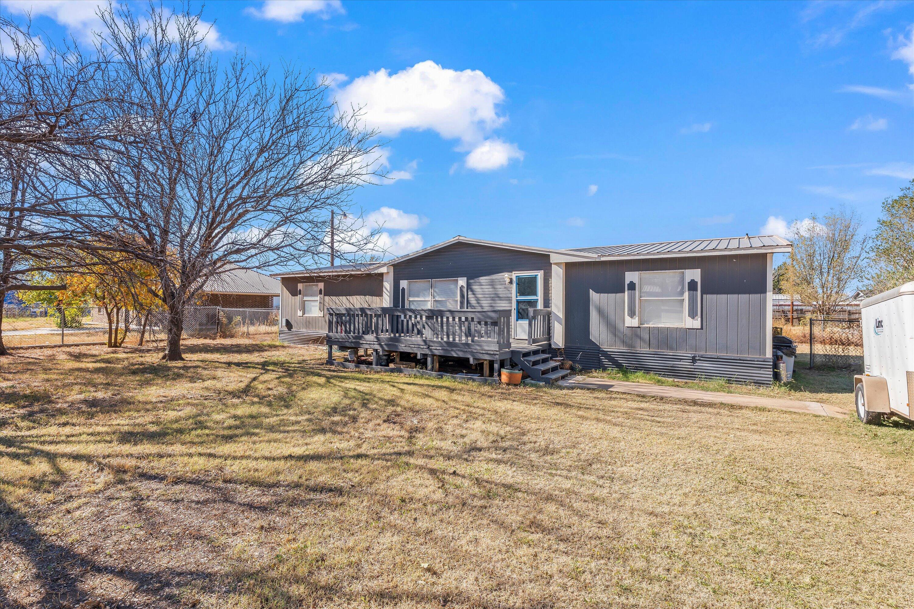 9909 North Chester Avenue Lubbock, TX 79415 - Photo 2 of 24 a view of a house with a yard covered in snow