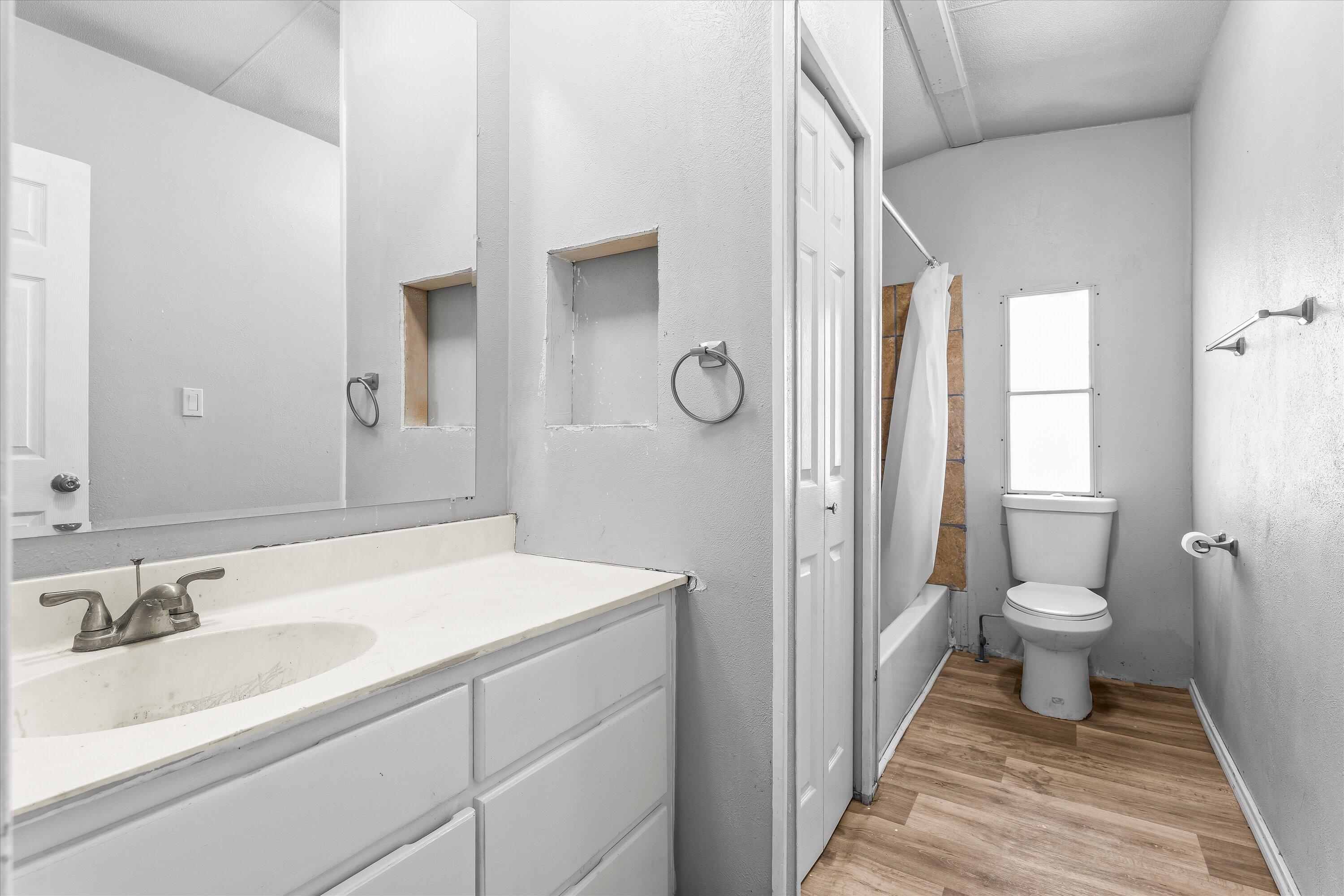 9909 North Chester Avenue Lubbock, TX 79415 - Photo 21 of 24 a bathroom with a sink and a mirror