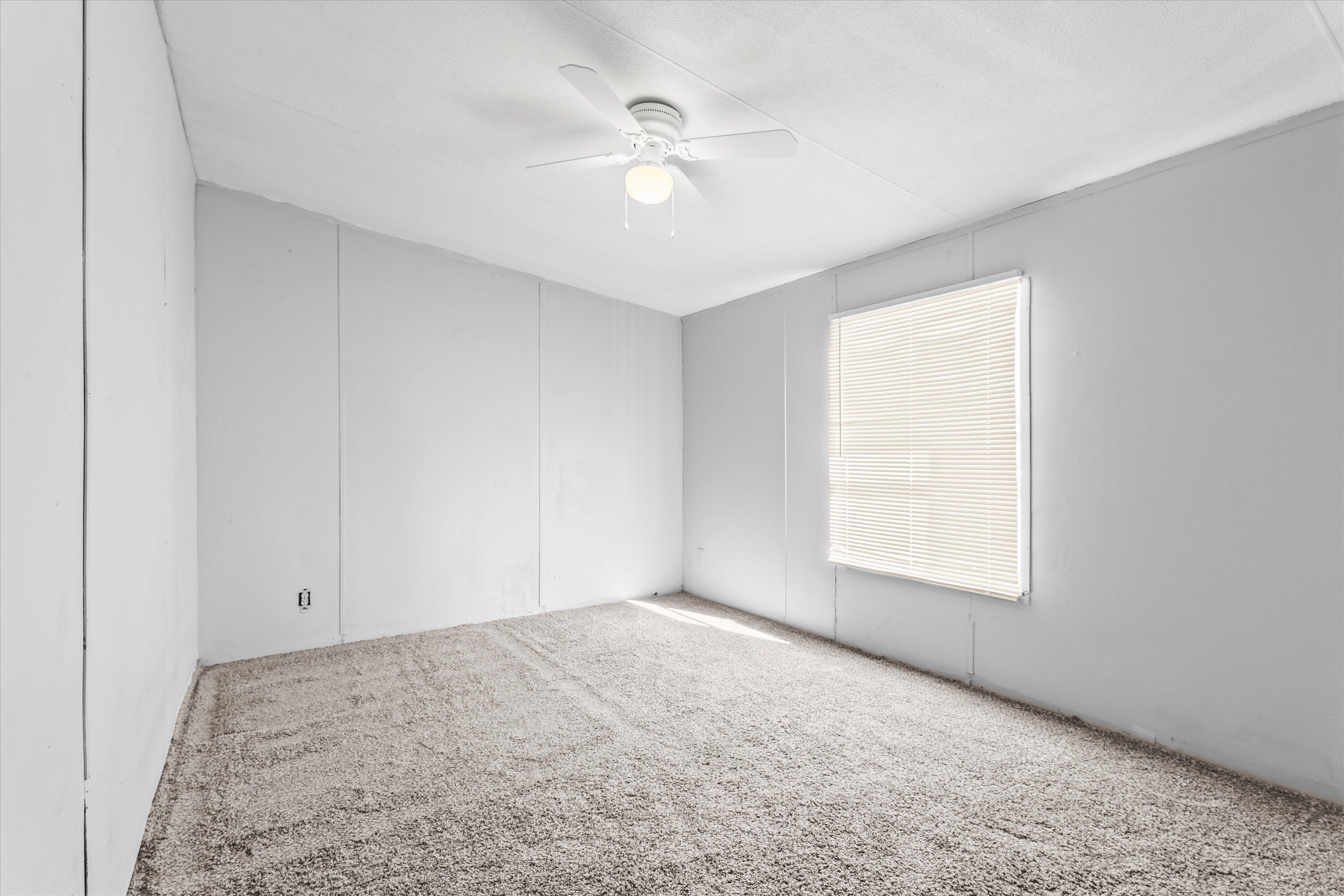 9909 North Chester Avenue Lubbock, TX 79415 - Photo 22 of 24 an empty room with windows and fan