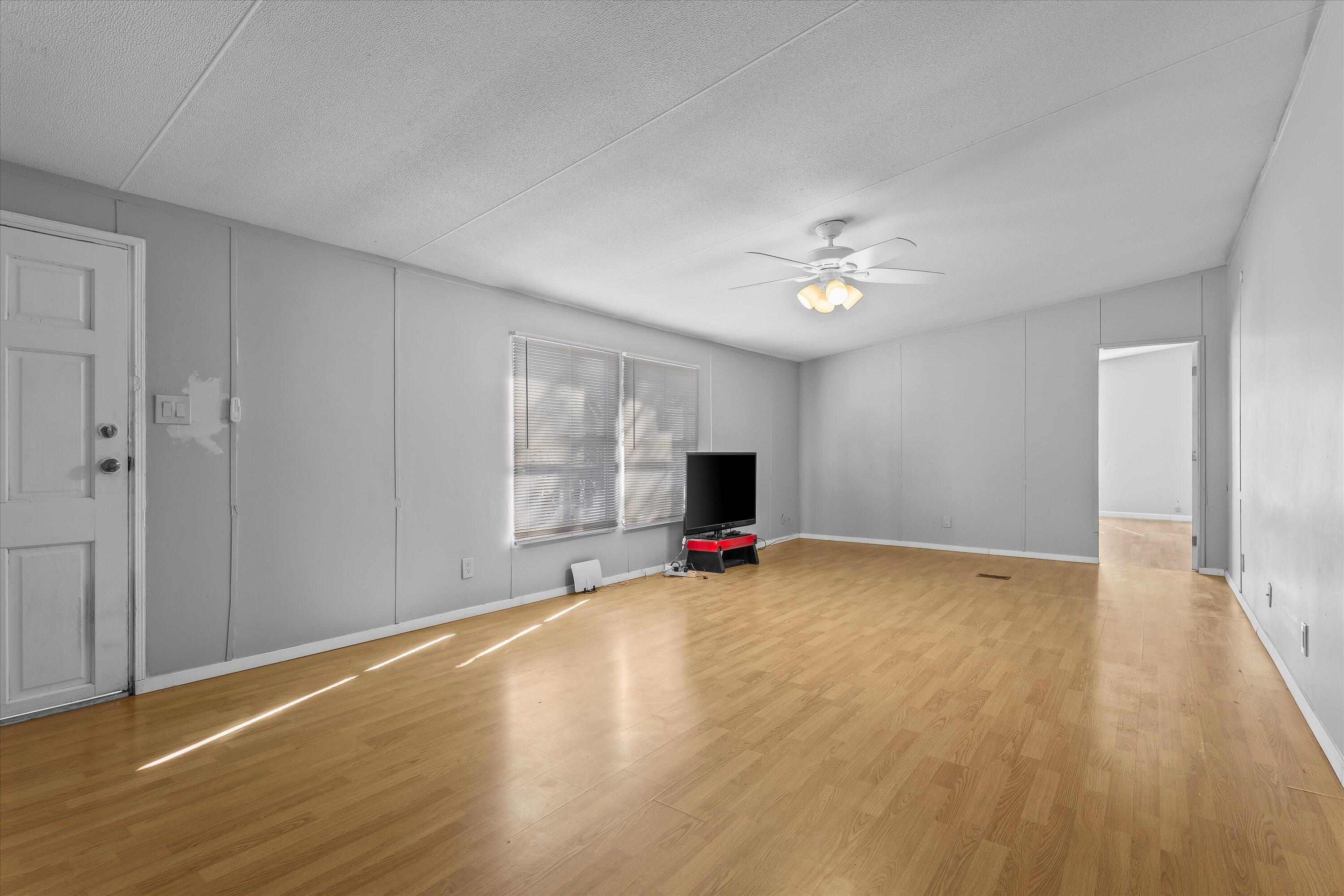 9909 North Chester Avenue Lubbock, TX 79415 - Photo 5 of 24 a view of empty room with wooden floor and fan