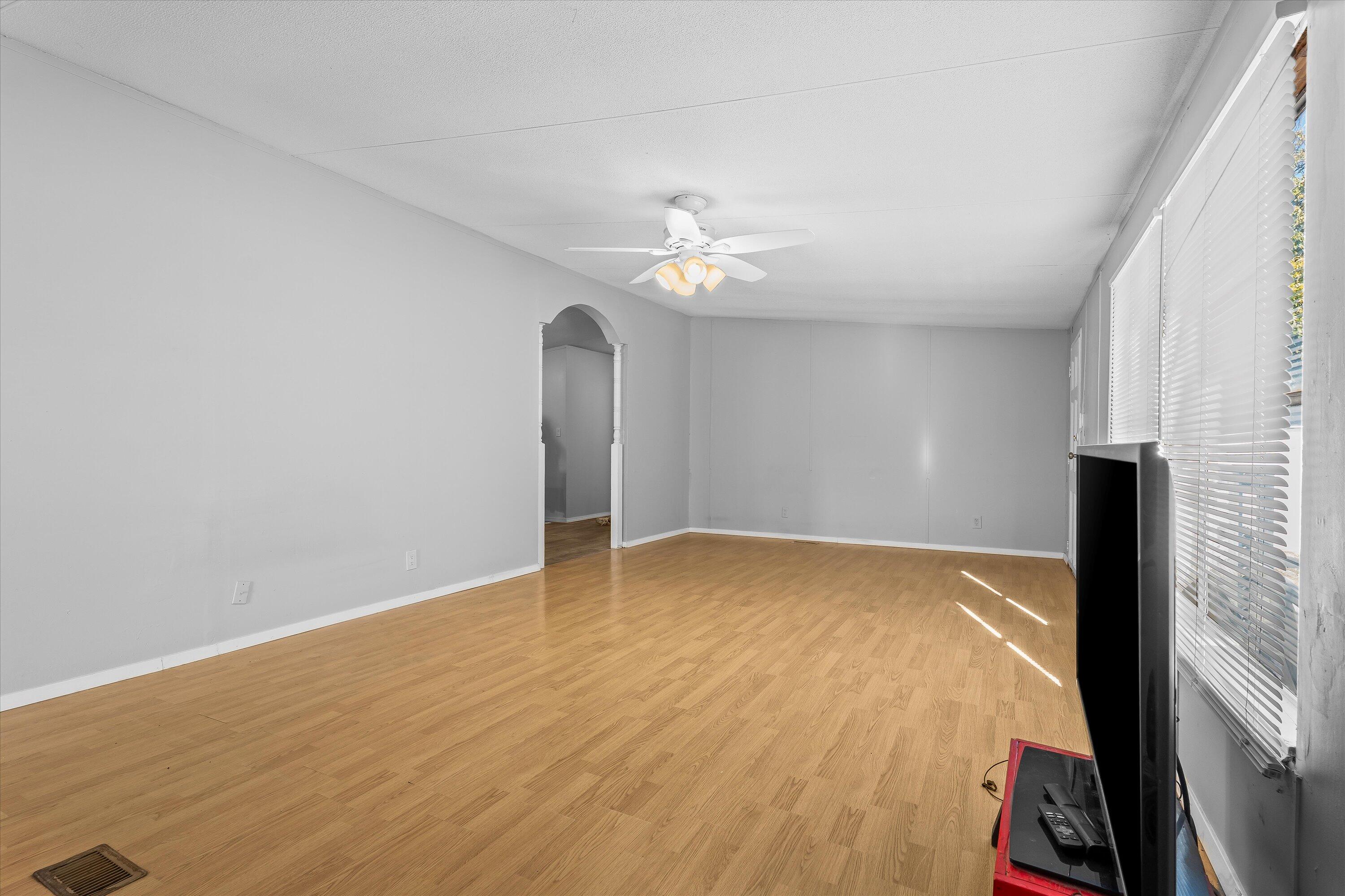 9909 North Chester Avenue Lubbock, TX 79415 - Photo 7 of 24 wooden floor in an empty room with a window