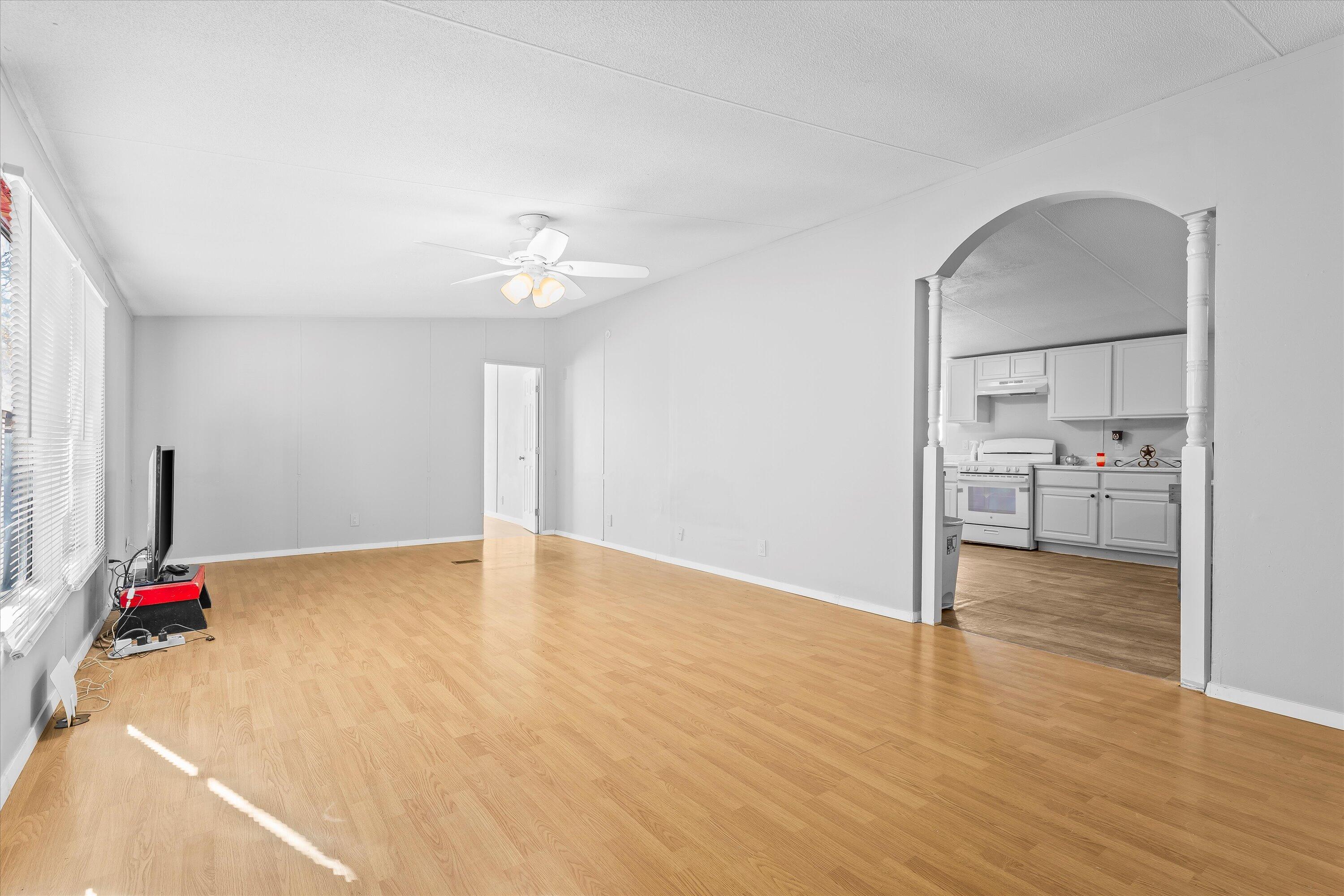 9909 North Chester Avenue Lubbock, TX 79415 - Photo 8 of 24 a view of an empty room with kitchen and a window