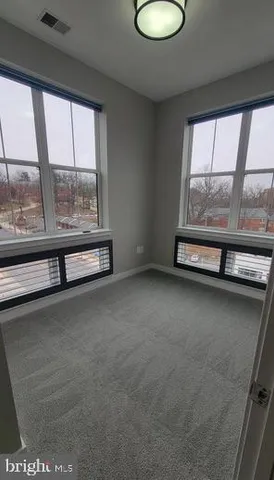 a view of an empty room and wooden floor