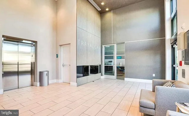 a bedroom with a bed and a large mirror