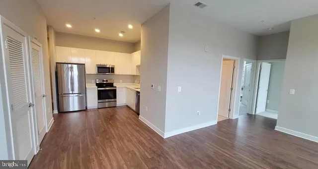 a kitchen with stainless steel appliances a sink a stove and microwave
