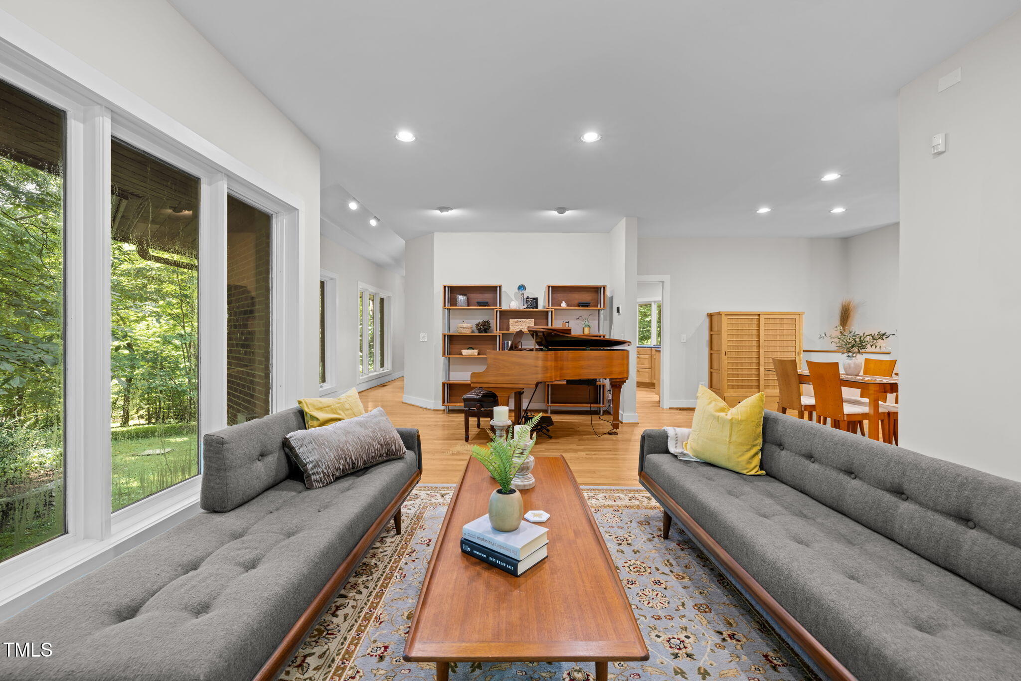 801 Creekstone Drive Chapel Hill, NC 27516 - Photo 8 of 65 a living room with furniture kitchen view and large windows