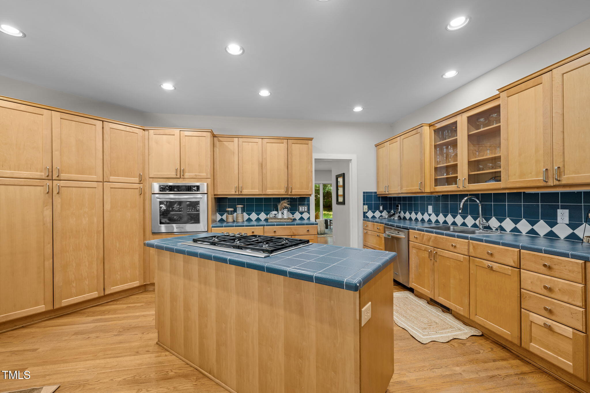 801 Creekstone Drive Chapel Hill, NC 27516 - Photo 12 of 65 a kitchen with stainless steel appliances granite countertop a stove a sink and a refrigerator