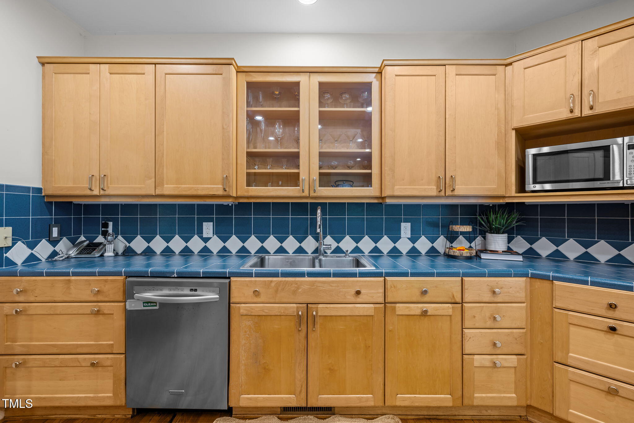 801 Creekstone Drive Chapel Hill, NC 27516 - Photo 14 of 65 a kitchen with granite countertop white cabinets and black stainless steel appliances